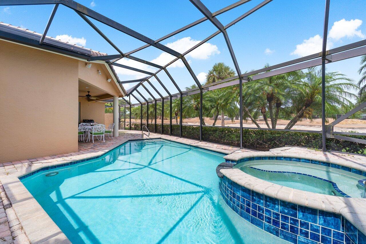 8161 Quail Meadow Way West Palm Beach, FL 33412 - Photo 18 of 36 a view of a swimming pool with a patio