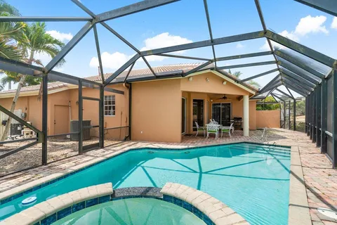 a view of a house with a backyard and patio