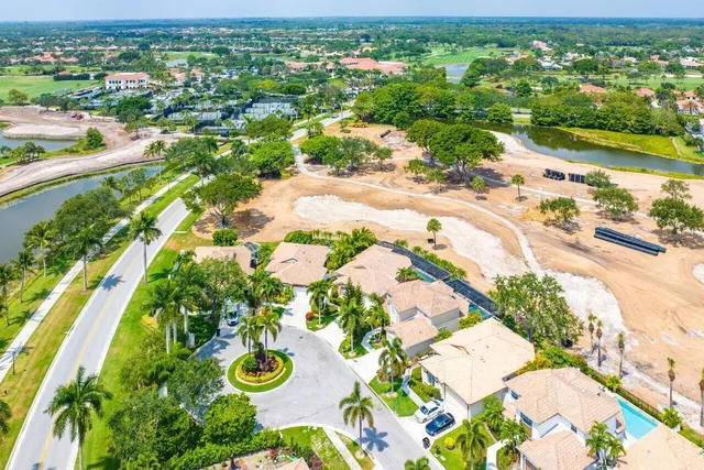 an aerial view of residential houses with outdoor space and street view