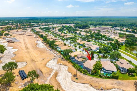 an aerial view of residential houses with outdoor space and trees