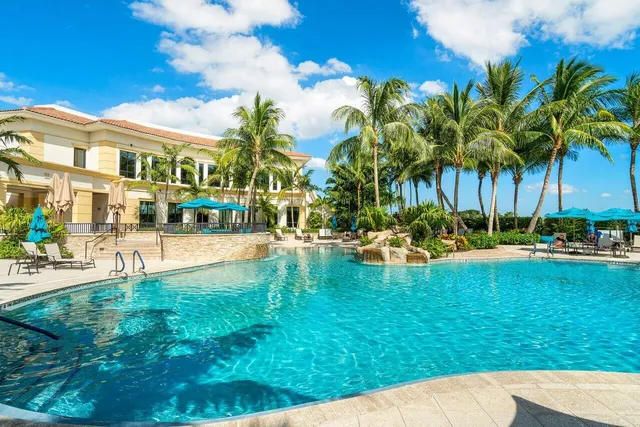 a swimming pool with outdoor seating and yard