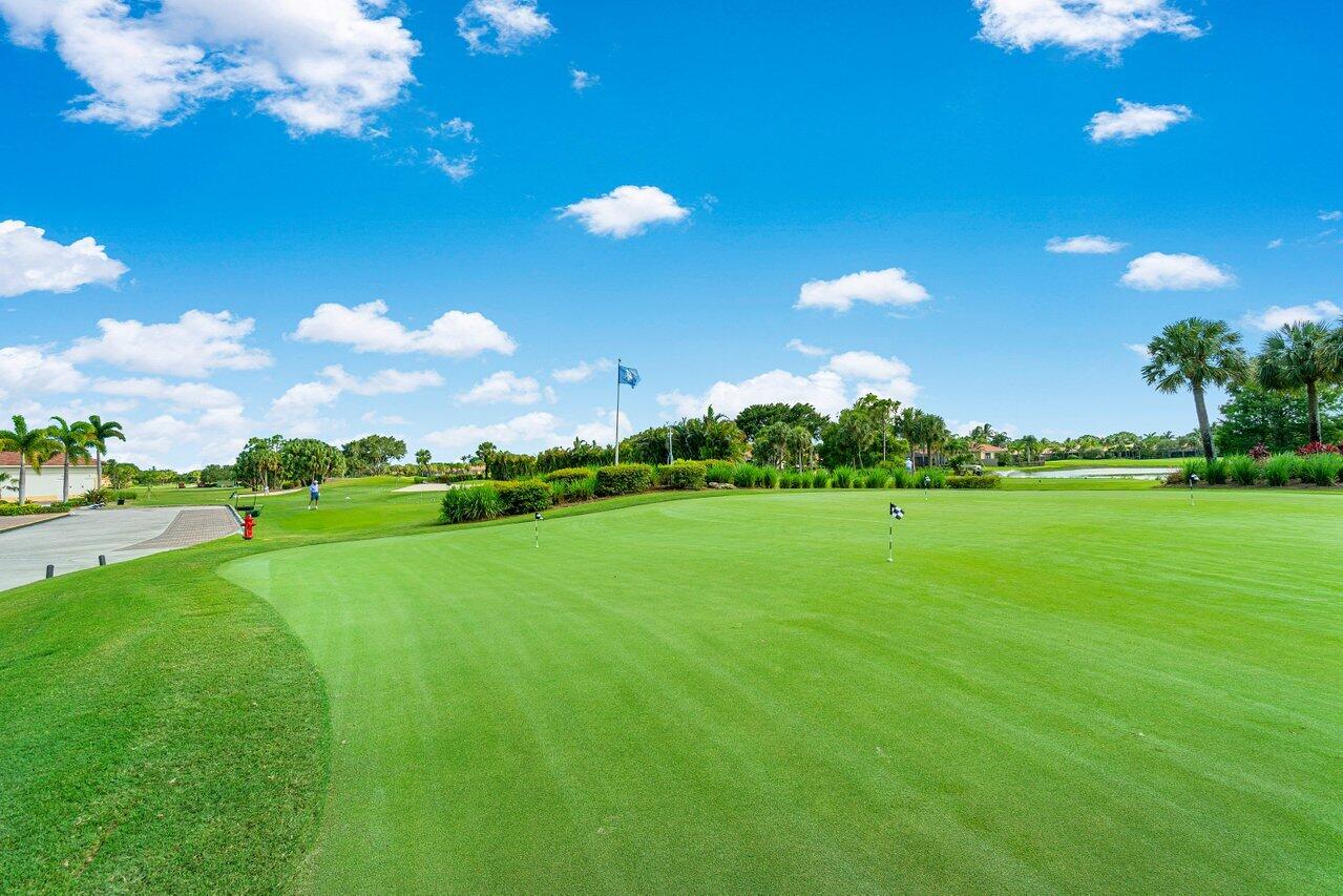 8161 Quail Meadow Way West Palm Beach, FL 33412 - Photo 33 of 36 a view of a golf course with an outdoor space and seating