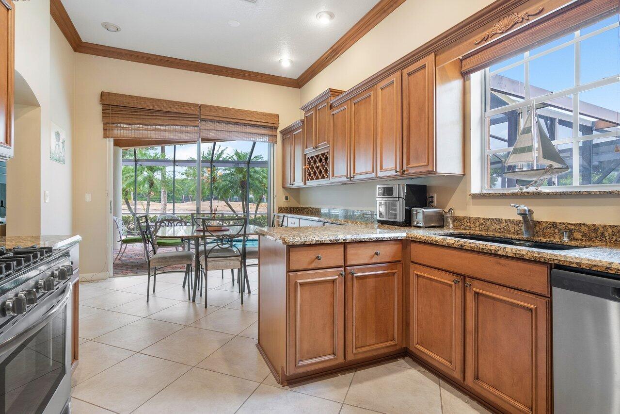8161 Quail Meadow Way West Palm Beach, FL 33412 - Photo 4 of 36 a kitchen with a stove a sink and a refrigerator