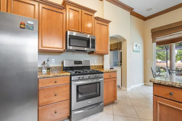a kitchen with stainless steel appliances granite countertop a stove and a microwave