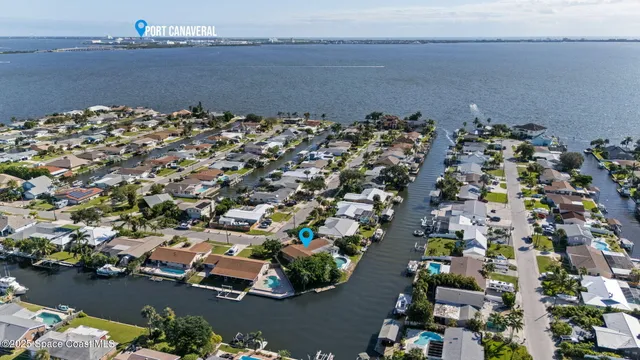 an aerial view of a houses with ocean view