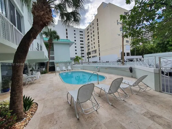 a view of a swimming pool with outdoor seating