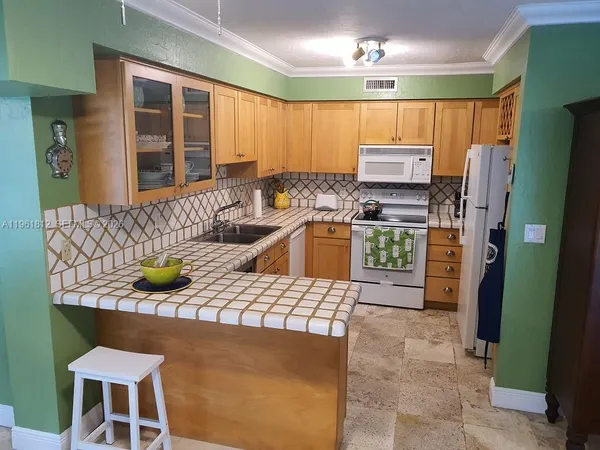 a kitchen with a stove sink and cabinets