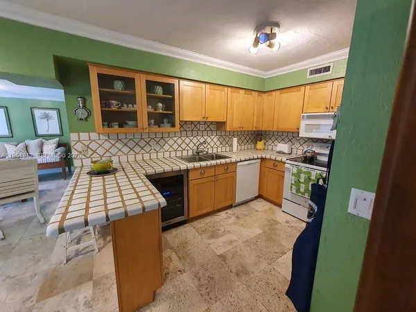 a kitchen with a sink appliances and cabinets