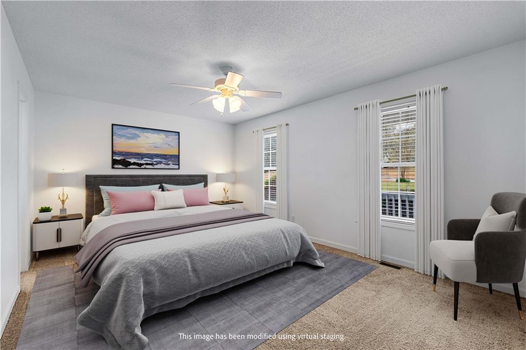 3048 Turner Church Road McDonough, GA 30252 - Photo 17 of 57 a bedroom with a bed a couch and a window