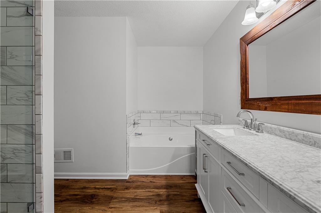 3048 Turner Church Road McDonough, GA 30252 - Photo 22 of 57 a bathroom with a granite countertop sink and a mirror