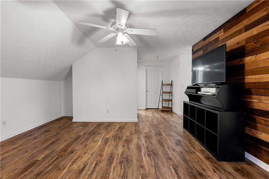 3048 Turner Church Road McDonough, GA 30252 - Photo 30 of 57 an empty room with wooden floor kitchen view and a window