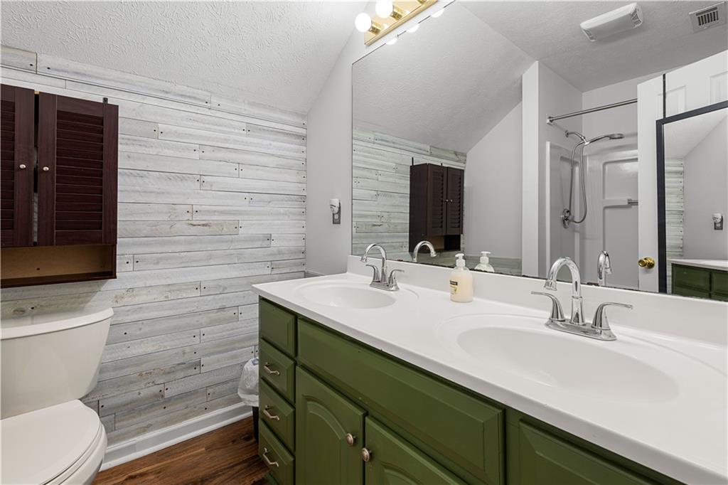 3048 Turner Church Road McDonough, GA 30252 - Photo 35 of 57 a bathroom with a toilet sink and mirror