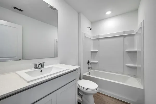 a bathroom with a sink double vanity granite toilet tub and shower