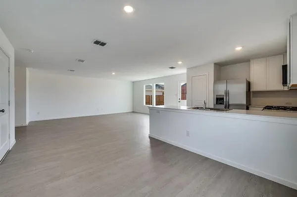 a view of kitchen with stainless steel appliances cabinets