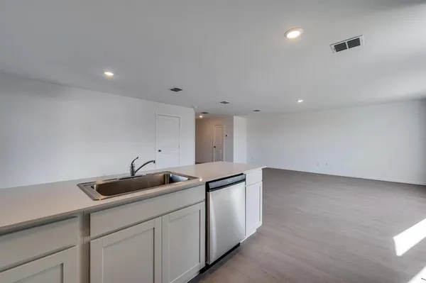 a kitchen with a sink and cabinets