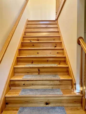a view of a bedroom with wooden floor