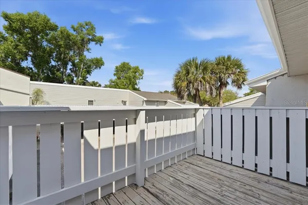 a view of a balcony with wooden fence