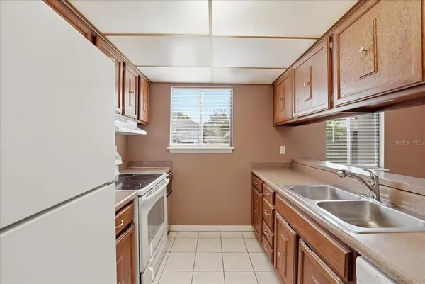 a kitchen that has a sink and a stove