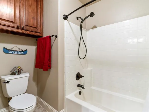 a bathroom with a granite countertop double vanity and a mirror