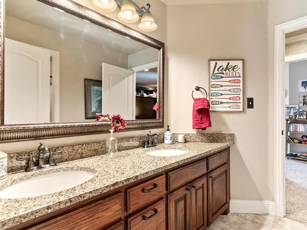 a bathroom with a sink double vanity and a mirror