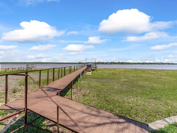 an aerial view of a house with a yard and trees