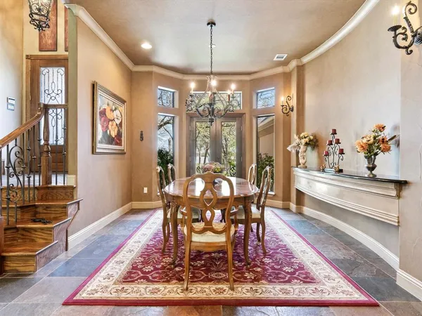 a dining room with furniture a chandelier and wooden floor