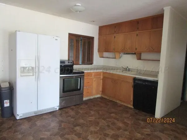 a kitchen with a stove and a refrigerator
