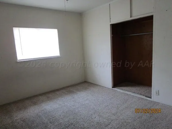 an empty room with a closet area
