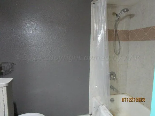 a bathroom with a bathtub and shower