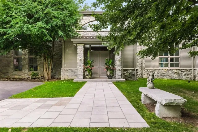 a view of a patio with a table and chairs and a small yard