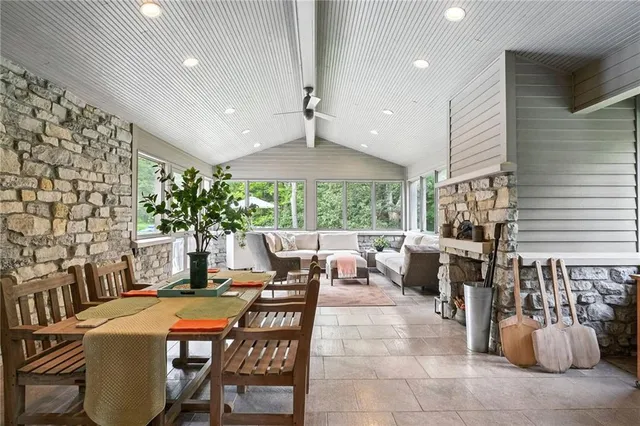 a dinning area with furniture and a large window