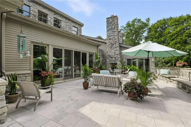 a view of a patio with furniture and a garden