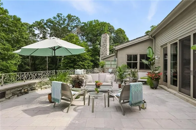 a view of backyard with outdoor seating and plants