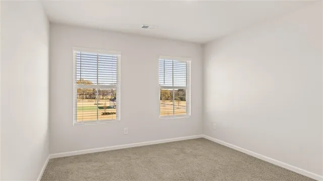a bathroom with a bathtub shower sink vanity mirror and toilet
