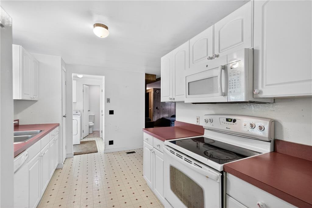 111 A Cowpath Road Aliquippa, PA 15001 - Photo 11 of 46 a kitchen with white cabinets and white appliances