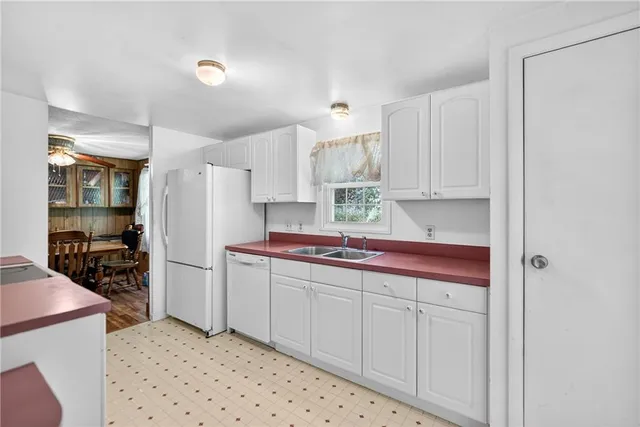 a kitchen with stainless steel appliances a refrigerator sink and cabinets