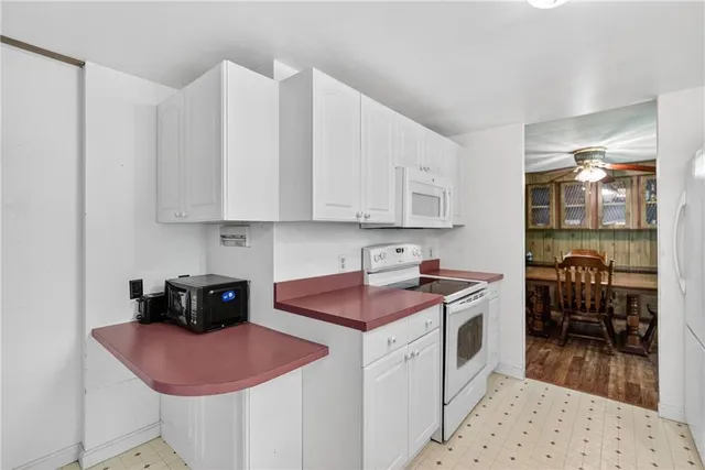 a kitchen with stainless steel appliances granite countertop a sink a stove and cabinets