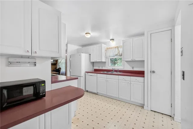 a kitchen with stainless steel appliances a stove a sink and a microwave