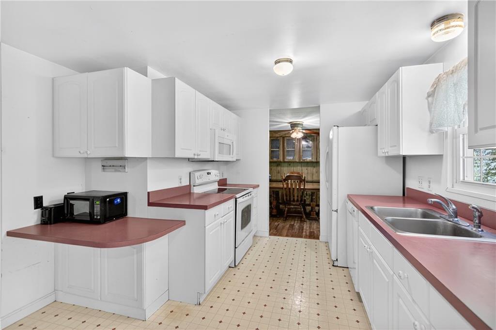 111 A Cowpath Road Aliquippa, PA 15001 - Photo 10 of 46 a kitchen with stainless steel appliances granite countertop a sink stove and refrigerator
