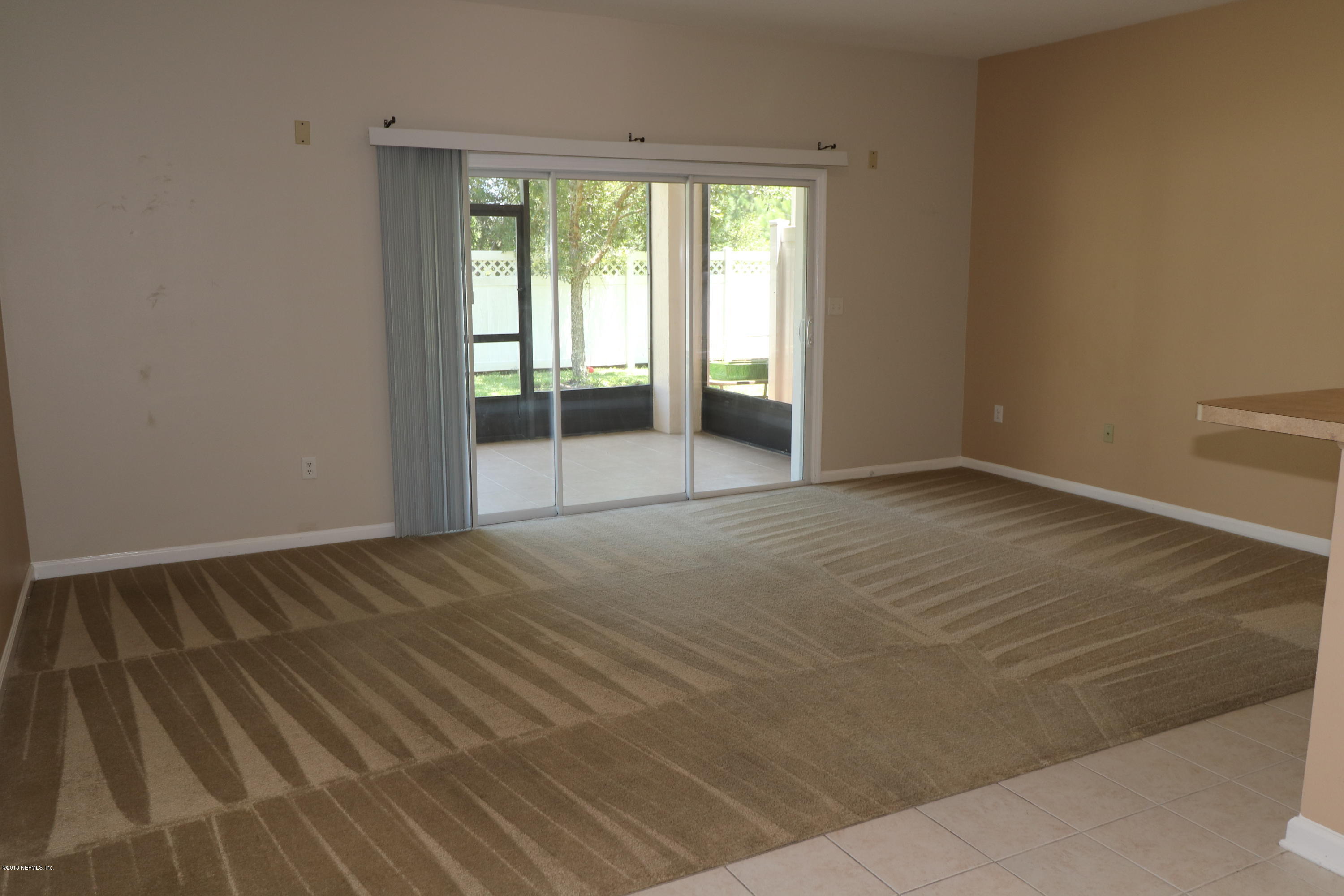 584 Crystal Way Orange Park, FL 32065 - Photo 12 of 14 a view of an empty room with wooden floor and a window