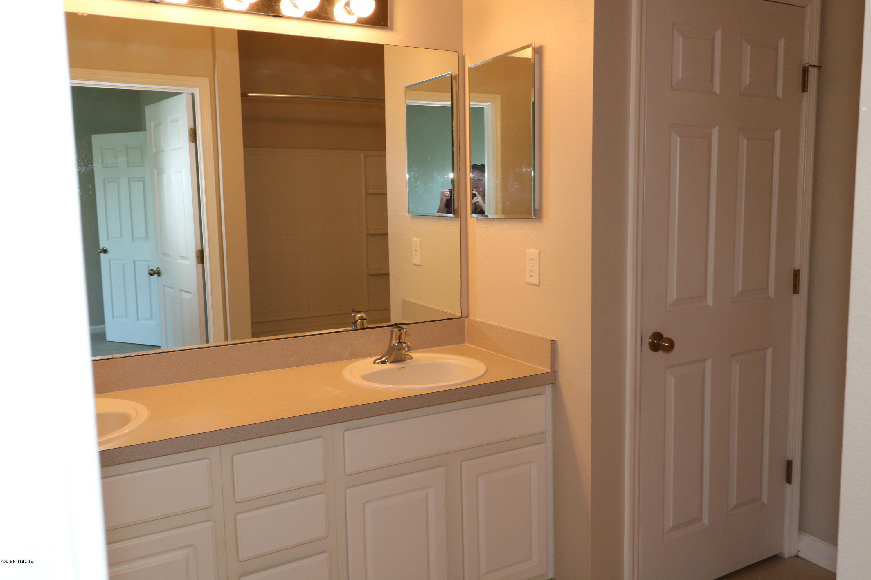 584 Crystal Way Orange Park, FL 32065 - Photo 13 of 14 a bathroom with a sink and a mirror