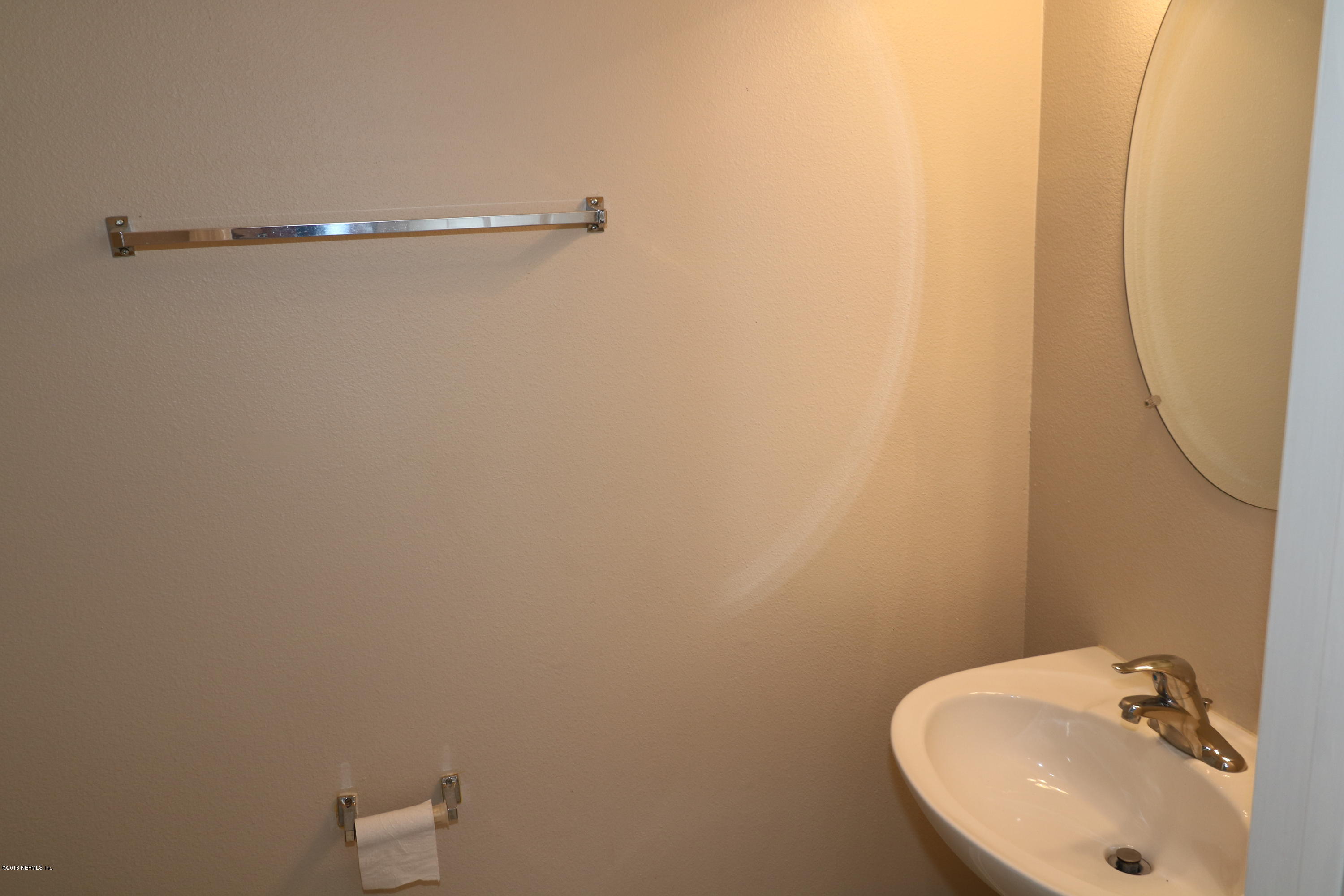 584 Crystal Way Orange Park, FL 32065 - Photo 5 of 14 a bathroom with a sink and a mirror