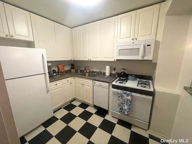 a kitchen with a stove a sink and a refrigerator