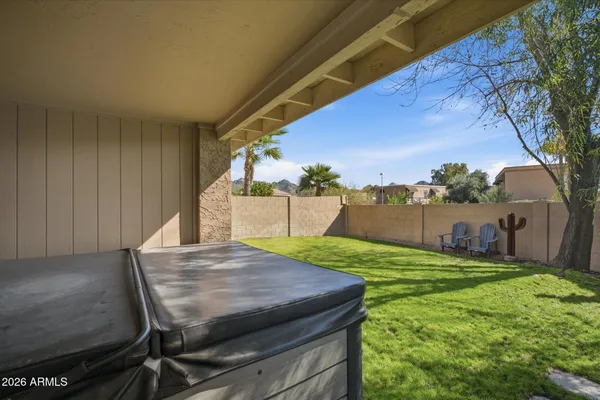 a backyard of a house with table and chairs
