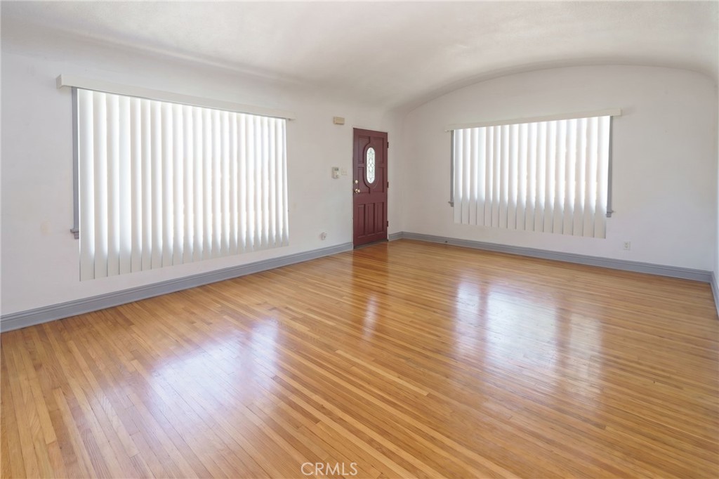 346 West School Street Compton, CA 90220 - Photo 10 of 29 an empty room with wooden floor and windows