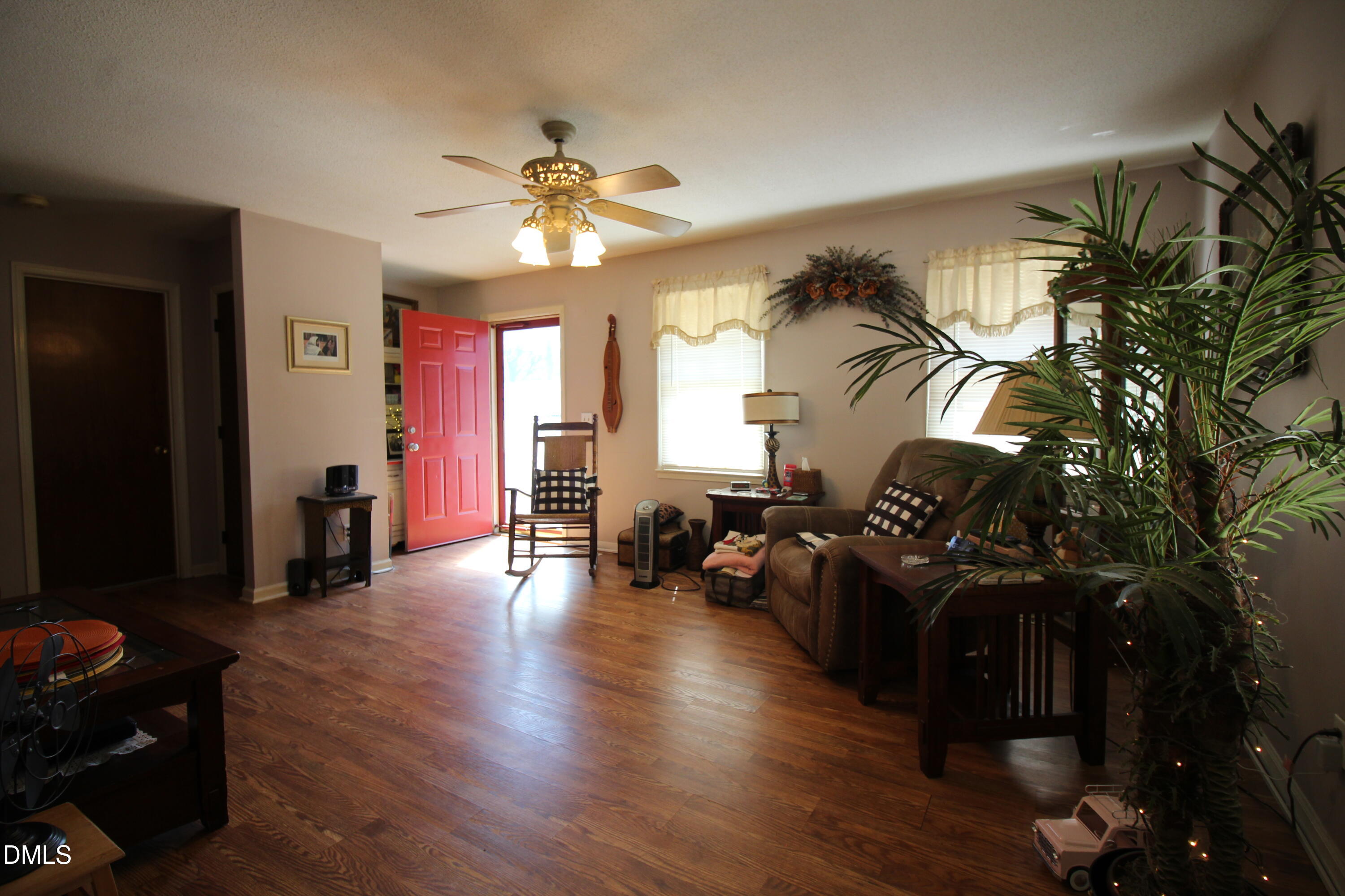 56 Ash Street Coats, NC 27521 - Photo 17 of 28 a living room with furniture and a chandelier