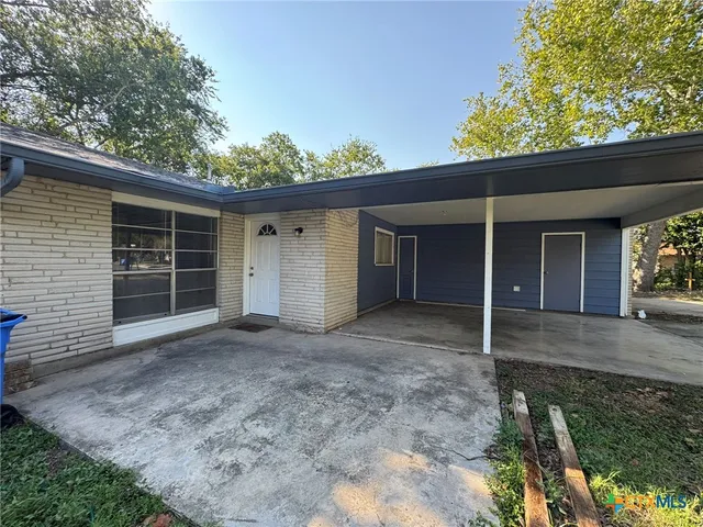 a view of a house with a yard and garage