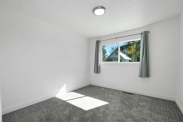 a bathroom with a granite countertop sink toilet and shower curtains