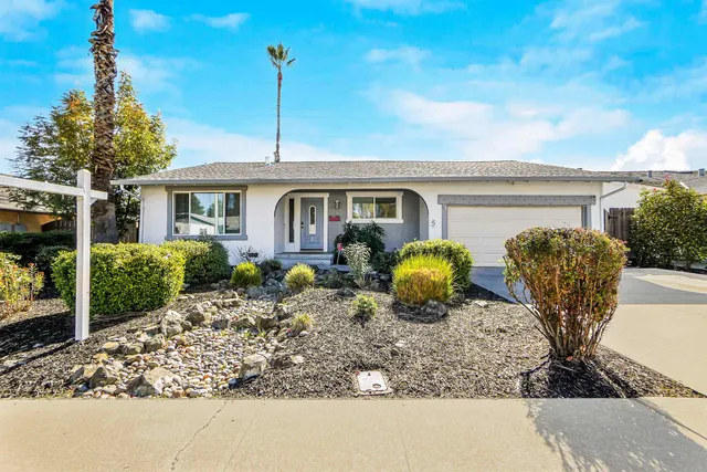 a view of a house with backyard and porch