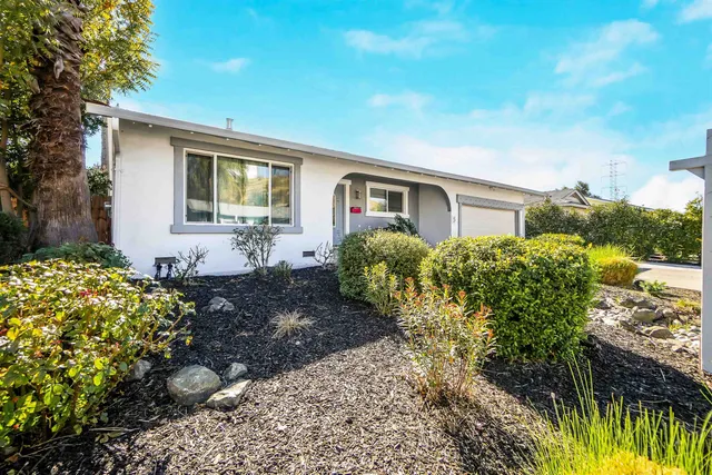 a view of a house with a yard and garden